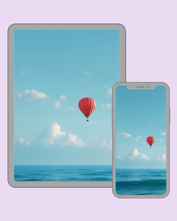 Red hot air balloon drifting above a calm blue ocean beneath a clear sky