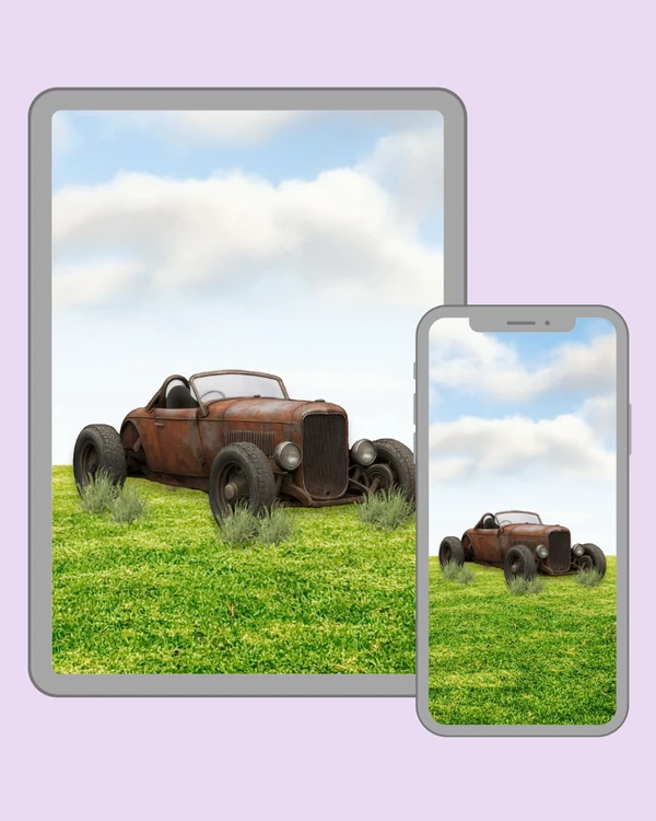 Rusty vintage hot rod parked peacefully in a grassy field