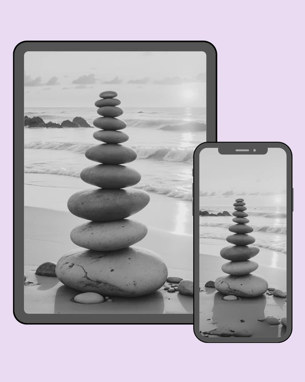 Tall stack of smooth stones beside gentle ocean waves